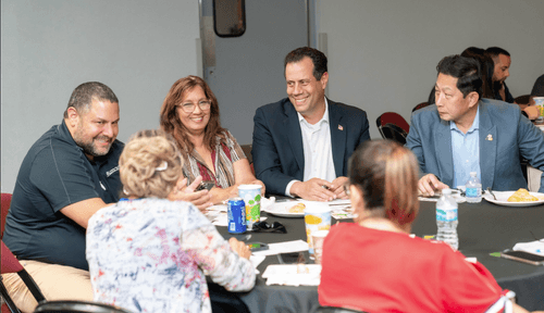People sit around a table sharing ideas